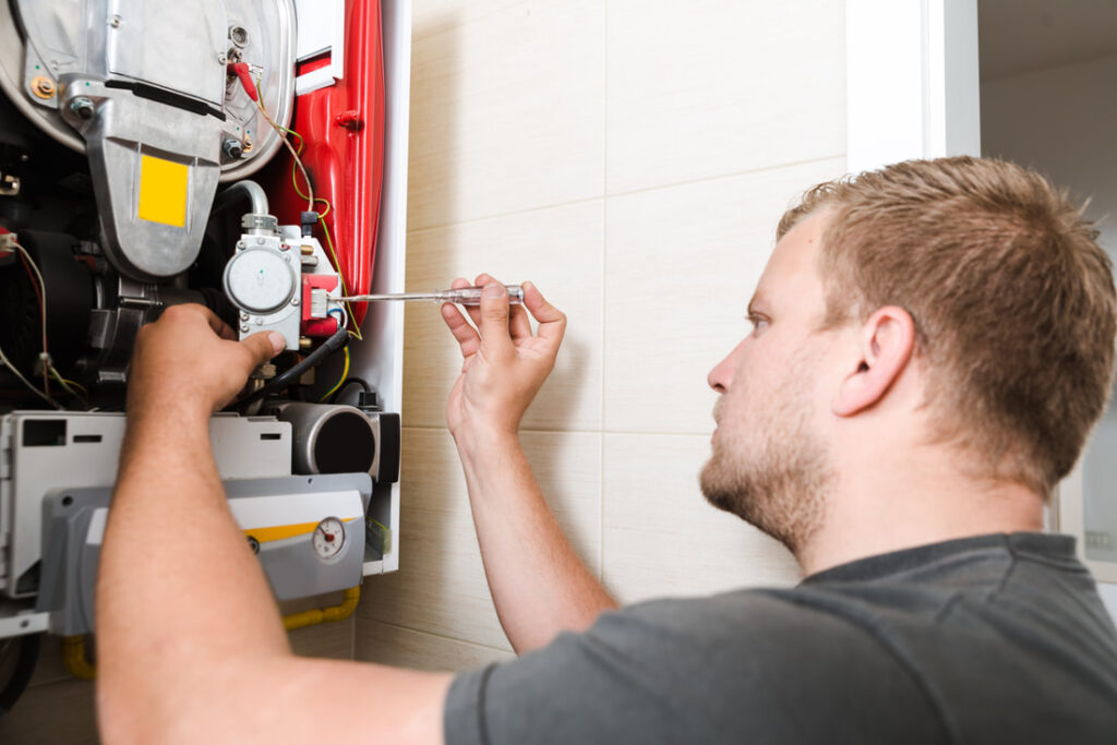 A technician working on a furnace