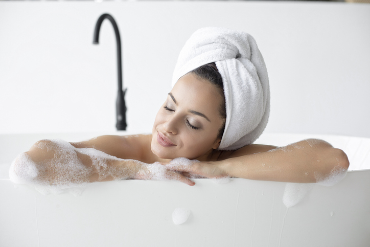 Woman relaxing in bathtub