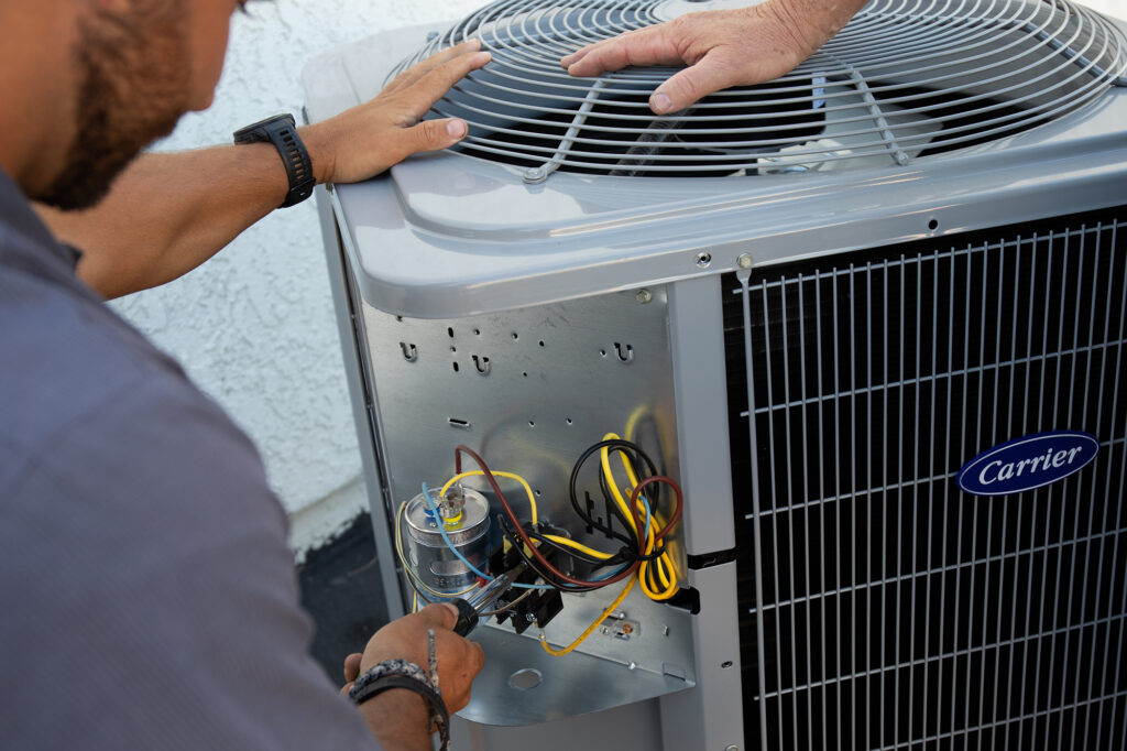 Tech servicing an air conditioning system in San Bernardino