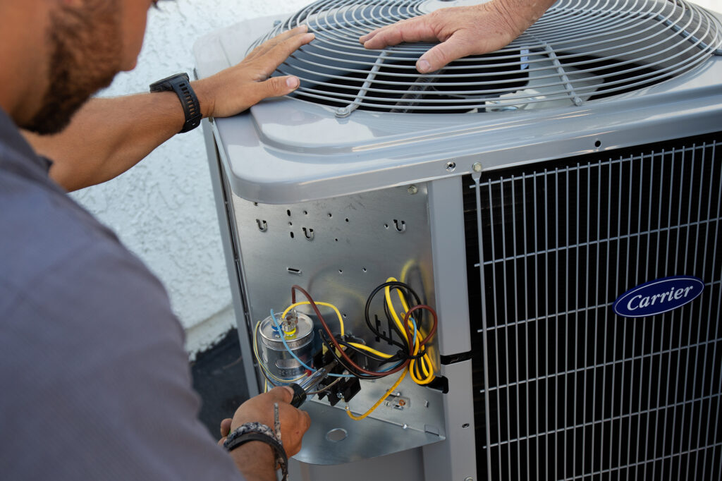 Technician repairing an AC system at a home in San Bernardino