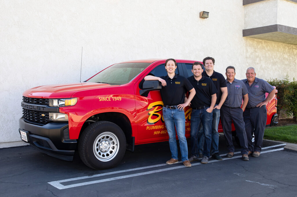 Ballard team member in front of an HVAC & Plumbing service truck in San Bernardino, CA