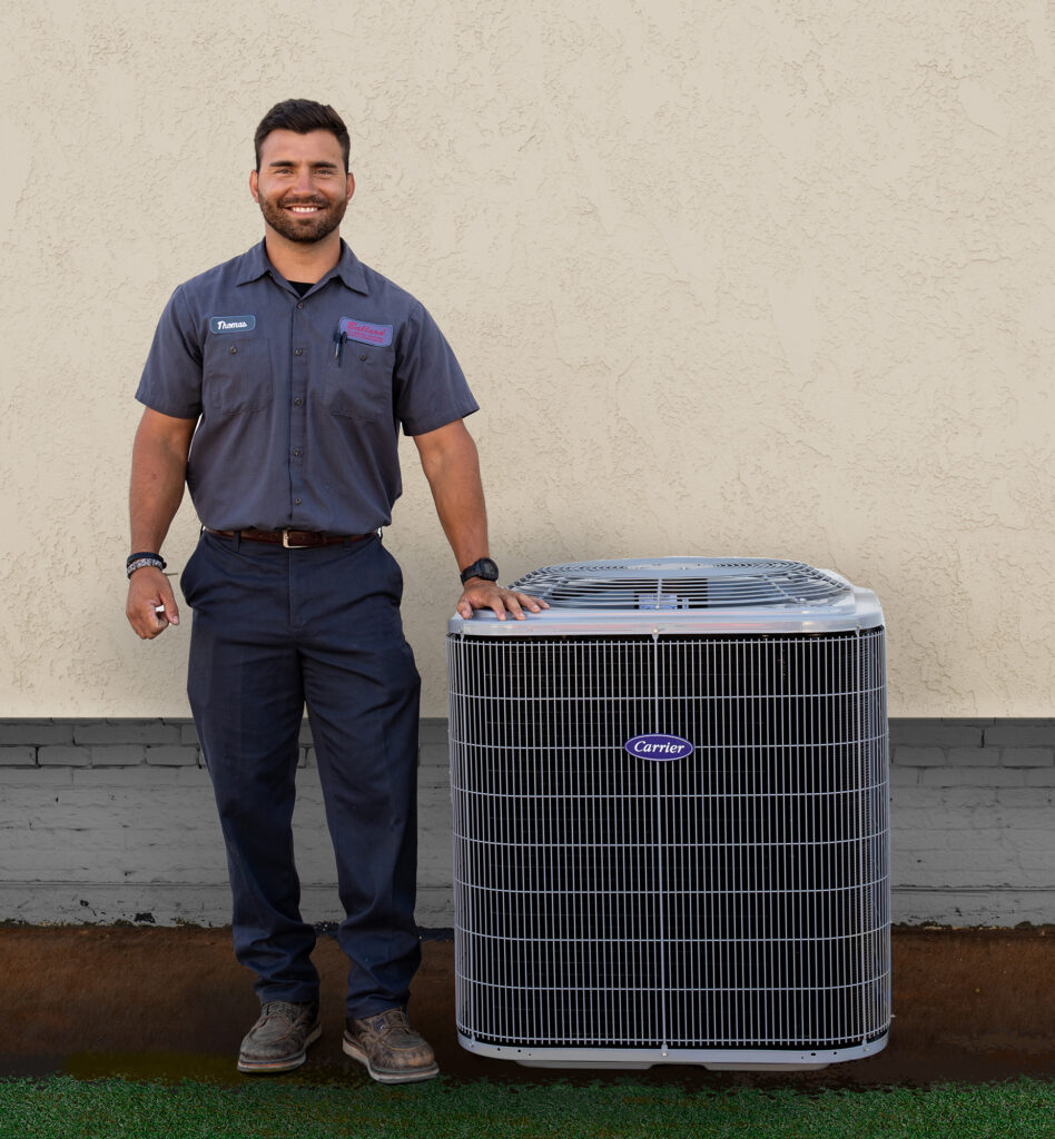 HVAC tech standing next to a new air conditioning system